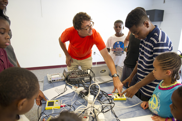 Jones shows kids how to use the touch-screen synthesizers