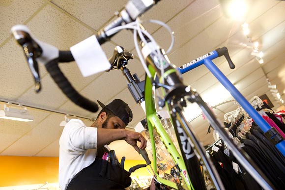 Brandon Lyles, a tech at Capitol Hill Bikes in Southeast, fixes a bike. He'll be volunteering his time to make sure residents East of the River can keep their bikes in working order