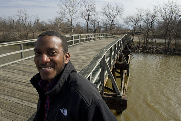 Bryant Curry, program coordinator for Kingman Island, at the bridge leading to the manmade island