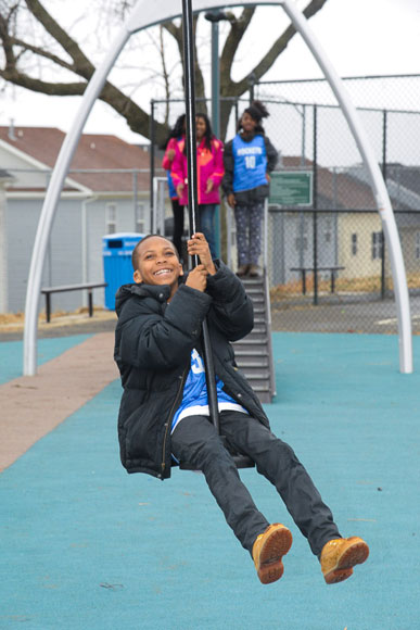A child rides a zip line at a renovated D.C. playground